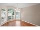 Dining room featuring laminate flooring, white walls, and windows with white shutters at 303 Rochester St, Spring Hill, FL 34609