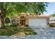 Charming single-Gathering home with a two-car garage and mature trees in a well-kept yard at 303 Rochester St, Spring Hill, FL 34609