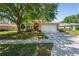Charming single-Gathering home with a two-car garage and mature trees in a well-kept yard at 303 Rochester St, Spring Hill, FL 34609