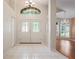 Bright foyer with tiled floor, double front doors with decorative glass, and high ceilings at 303 Rochester St, Spring Hill, FL 34609