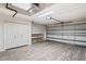 Spacious two-car garage with ample storage, updated flooring, and automatic door opener for convenience at 303 Rochester St, Spring Hill, FL 34609