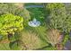 Aerial view of a white gazebo surrounded by lush green landscaping and mature trees on a sunny day at 303 Rochester St, Spring Hill, FL 34609