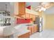 Bright kitchen featuring stainless steel appliances, white countertops, and light brown cabinets at 303 Rochester St, Spring Hill, FL 34609