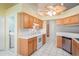 Bright kitchen featuring white countertops, light brown cabinets, and stainless steel appliances at 303 Rochester St, Spring Hill, FL 34609