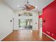 Spacious living room featuring hardwood floors, a ceiling fan, and sliding glass doors to the patio at 303 Rochester St, Spring Hill, FL 34609