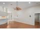 Open living area with high ceilings, hardwood floors, and seamless flow to the kitchen at 303 Rochester St, Spring Hill, FL 34609