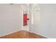 Open living area featuring laminate flooring and white walls that lead into the kitchen at 303 Rochester St, Spring Hill, FL 34609