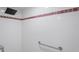Bathroom with a shower that has white tile and red trim at 303 Rochester St, Spring Hill, FL 34609
