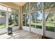 Bright sunroom with vinyl floors and large glass windows and a back door at 303 Rochester St, Spring Hill, FL 34609
