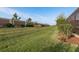 Expansive backyard with well-maintained lawn, tasteful landscaping, and secure stone perimeter wall at 3056 Francoa Dr, Odessa, FL 33556
