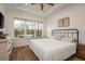Sun-filled main bedroom with hardwood floors and a view of the screened in porch at 3056 Francoa Dr, Odessa, FL 33556