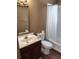 Cozy bathroom featuring dark cabinets, a white bathtub, and a single sink at 315 Highland St, Brooksville, FL 34601
