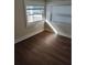 Bedroom with hardwood floors and natural light streaming in from multiple windows at 315 Highland St, Brooksville, FL 34601