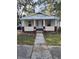 Charming bungalow with a red and yellow facade, inviting front porch, and traditional architectural details at 315 Highland St, Brooksville, FL 34601