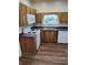 Kitchen with wood cabinets, white appliances, and stainless steel sink at 315 Highland St, Brooksville, FL 34601