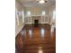 Sun-drenched living room boasting gleaming hardwood floors and a cozy fireplace at 315 Highland St, Brooksville, FL 34601
