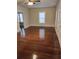 Spacious living room with hardwood floors, base trim, and large windows with natural light at 315 Highland St, Brooksville, FL 34601