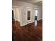 Open living room boasts gleaming hardwood floors and vintage architectural details at 315 Highland St, Brooksville, FL 34601