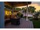 Outdoor lounge area with a plush couch, fire pit, and views of the surrounding greenery at 3167 Bay Ln, Clearwater, FL 33759