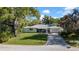 Charming single-story home featuring a well-manicured lawn, screened lanai, and attached garage at 3167 Bay Ln, Clearwater, FL 33759