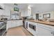 Bright kitchen offers stainless appliances, granite counters, white cabinets, and a functional layout at 3167 Bay Ln, Clearwater, FL 33759