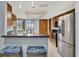 Well-equipped kitchen featuring stainless steel appliances, breakfast bar and ample natural light at 3450 Dow Lane, Spring Hill, FL 34608