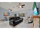Spacious living room with tile floors, high ceilings with ceiling fans and a cozy fireplace at 3450 Dow Lane, Spring Hill, FL 34608