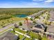 This aerial view shows the home in relation to the neighborhood pond and wooded areas at 3600 Tuckerton Dr, Land O Lakes, FL 34638