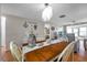 Dining area with chandelier opens to living room and offers seating for four on wood floors at 4266 Tamargo Dr # 4266, New Port Richey, FL 34652