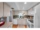 Bright kitchen featuring white appliances and light-colored cabinets with a light-colored countertop at 4266 Tamargo Dr # 4266, New Port Richey, FL 34652