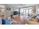 Comfortable living room with hardwood floors and lots of natural light from the glass enclosed lanai at 4266 Tamargo Dr # 4266, New Port Richey, FL 34652