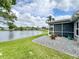 Lakefront property boasting an expansive lawn, stone patio, and beautiful views of the water at 4420 Devon Dr, New Port Richey, FL 34653