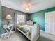 Cozy bedroom features neutral walls, tile flooring, and a decorative ceiling fan at 4420 Devon Dr, New Port Richey, FL 34653