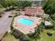Aerial view of a community pool with ample seating, lush landscaping, and hot tub at 4420 Devon Dr, New Port Richey, FL 34653