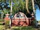 Millpond Estates entrance sign framed by palm trees creates a welcoming community atmosphere at 4420 Devon Dr, New Port Richey, FL 34653