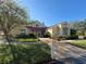Clubhouse exterior featuring a charming entrance, well-manicured landscaping, and inviting walkway at 4420 Devon Dr, New Port Richey, FL 34653