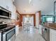Spacious kitchen featuring granite counters, stainless steel appliances, and white cabinets at 4420 Devon Dr, New Port Richey, FL 34653