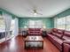 A spacious living room with views of the lake, hardwood floors, and comfortable seating at 4420 Devon Dr, New Port Richey, FL 34653