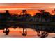 Beautiful pond view reflecting a stunning sunrise over the neighborhood homes and palm trees at 4420 Devon Dr, New Port Richey, FL 34653