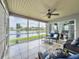 Enjoy water views from a serene screened porch, tiled and furnished for relaxation at 4420 Devon Dr, New Port Richey, FL 34653