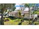 Landscaped front yard with palm trees and side patio at 4515 Blanche St, New Port Richey, FL 34652