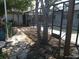 View of the backyard with trees, pavers, and partially enclosed pool at 4607 N Saint Vincent St, Tampa, FL 33614
