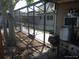 View of the backyard with outdoor kitchen and a partially enclosed pool at 4607 N Saint Vincent St, Tampa, FL 33614