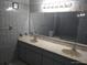Bathroom features a double sink vanity with updated fixtures and a large mirror at 4607 N Saint Vincent St, Tampa, FL 33614