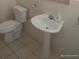 Bathroom showcasing pedestal sink and toilet with tiled floor at 4607 N Saint Vincent St, Tampa, FL 33614