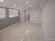 Bedroom featuring tile flooring and view of full bathroom at 4607 N Saint Vincent St, Tampa, FL 33614