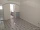 Bedroom featuring tile flooring and open access to bathroom at 4607 N Saint Vincent St, Tampa, FL 33614