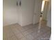 Empty bedroom with neutral paint and tile floors at 4607 N Saint Vincent St, Tampa, FL 33614