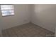 Bedroom showing tile flooring and a window with blinds at 4607 N Saint Vincent St, Tampa, FL 33614