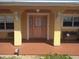 Charming entrance with arched entryway, sidelights, and a cozy tiled porch at 4607 N Saint Vincent St, Tampa, FL 33614
